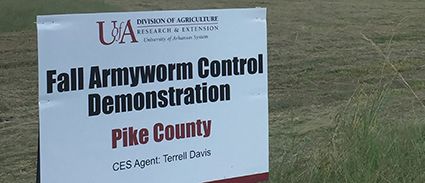 Grassy field with UADA Fall Armyworm Control Demonstration for Pike COunty sign